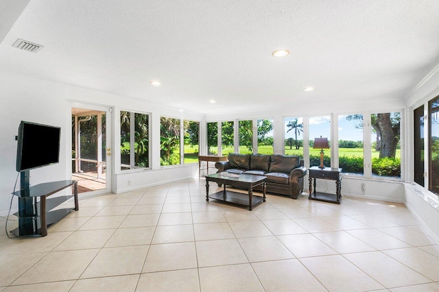 living room with ceiling fan and light tile patterned floors