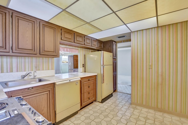 kitchen with sink, light tile patterned flooring, and white appliances