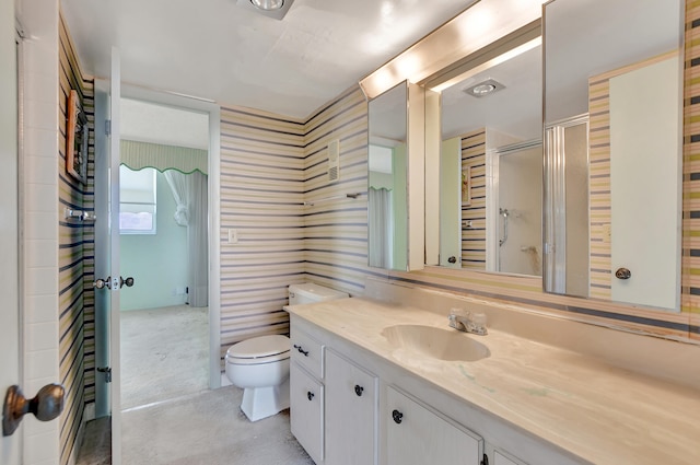 bathroom featuring toilet and vanity