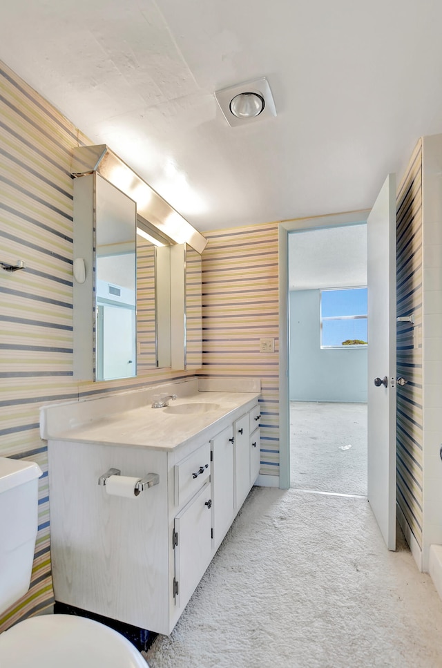 bathroom with toilet and vanity