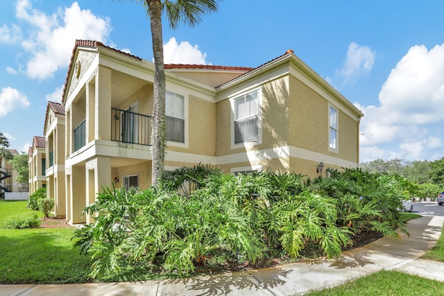 view of home's exterior with a balcony