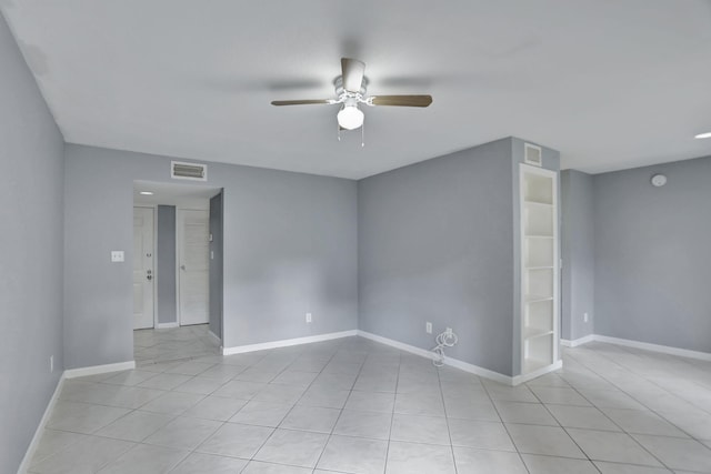 tiled empty room featuring ceiling fan