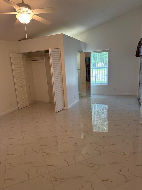 unfurnished bedroom featuring ceiling fan and vaulted ceiling