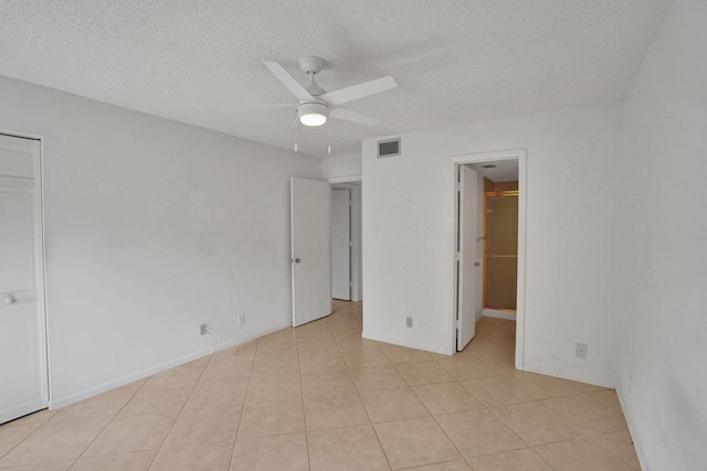 442 Pine Glen Ln Unit B2, Greenacres, FL 33463 - unfurnished bedroom with a textured ceiling, light tile patterned floors, a ceiling fan, and visible vents