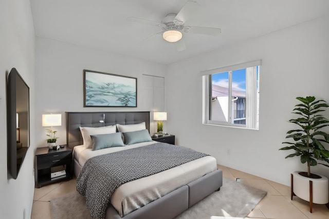 tiled bedroom featuring ceiling fan