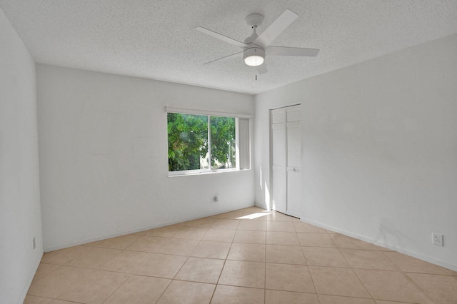 442 Pine Glen Ln Unit B2, Greenacres, FL 33463 - empty room featuring a textured ceiling, ceiling fan, and tile patterned flooring