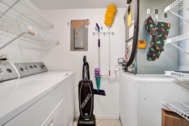 clothes washing area with electric panel and separate washer and dryer