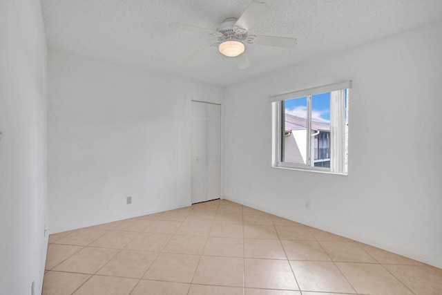 442 Pine Glen Ln Unit B2, Greenacres, FL 33463 - empty room featuring a textured ceiling, ceiling fan, and tile patterned flooring