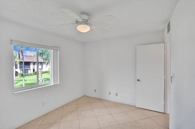 442 Pine Glen Ln Unit B2, Greenacres, FL 33463 - spare room with a textured ceiling, light tile patterned floors, and a ceiling fan