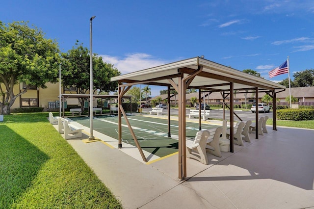 surrounding community with shuffleboard and a yard