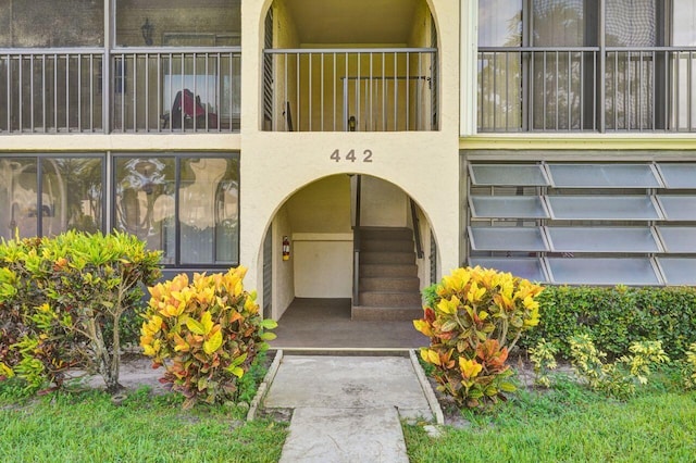 doorway to property featuring stucco siding