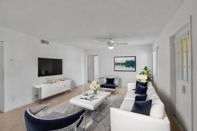 living area featuring a ceiling fan, light tile patterned flooring, and visible vents