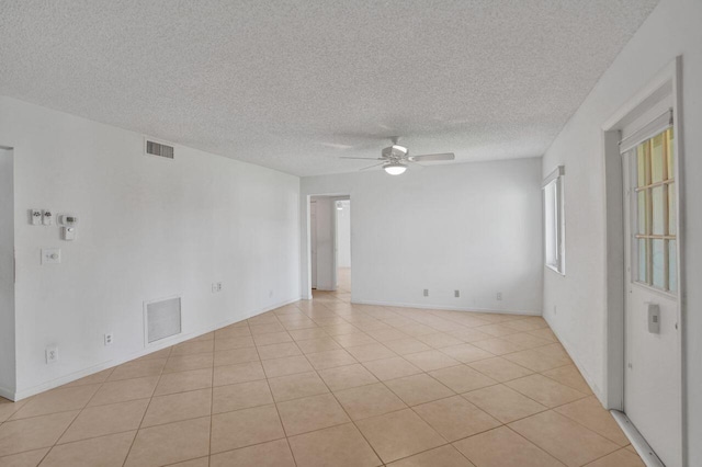 442 Pine Glen Ln Unit B2, Greenacres, FL 33463 - empty room with a textured ceiling, light tile patterned floors, a ceiling fan, and visible vents