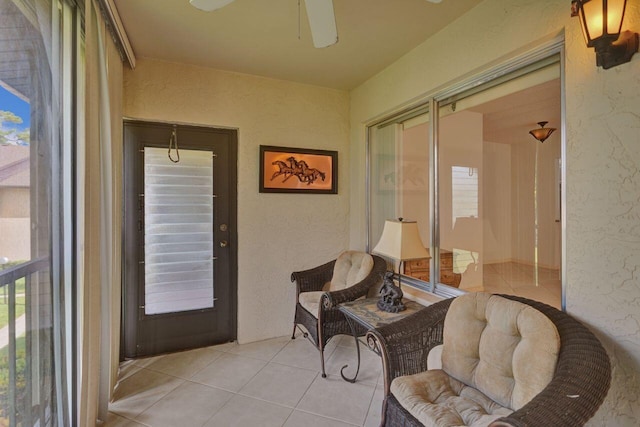 sunroom / solarium featuring ceiling fan