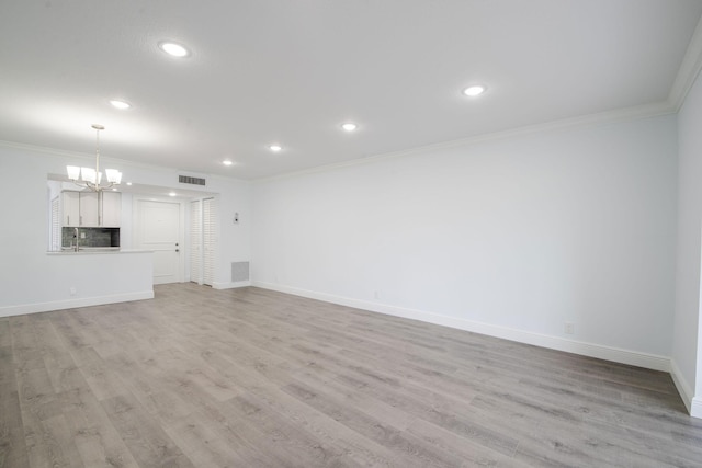 unfurnished living room featuring a chandelier, ornamental molding, recessed lighting, baseboards, and light wood-style flooring