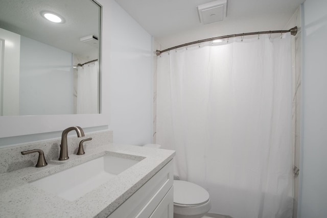bathroom with toilet, vanity, and a shower with shower curtain