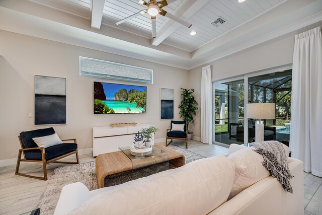 living room featuring ceiling fan, beam ceiling, light hardwood / wood-style floors, and a tray ceiling