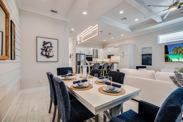 dining room with ceiling fan, light hardwood / wood-style floors, ornamental molding, and coffered ceiling