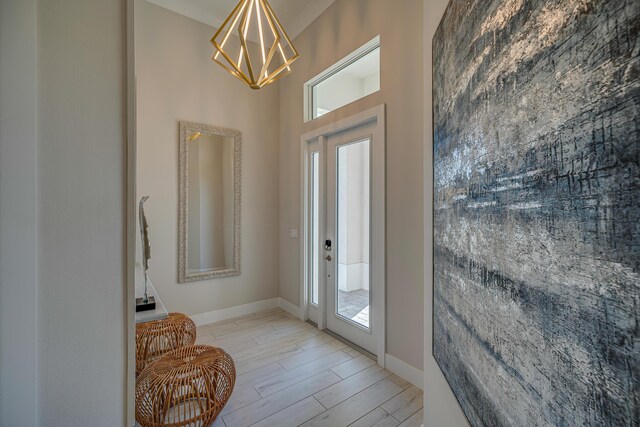 doorway with light hardwood / wood-style flooring and an inviting chandelier