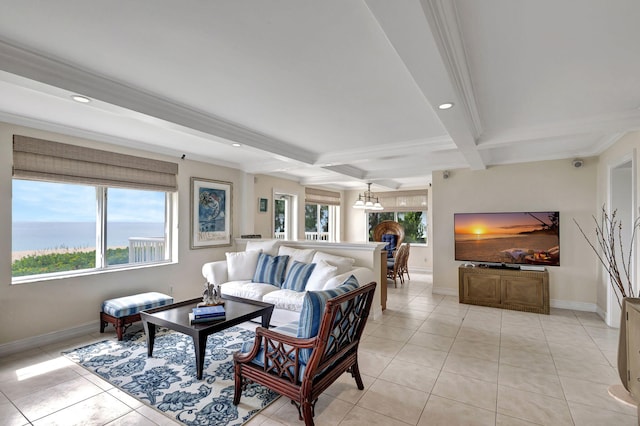 tiled living room with a water view, a wealth of natural light, an inviting chandelier, and beamed ceiling