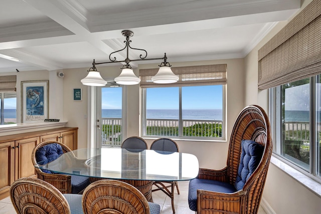 tiled dining area featuring a healthy amount of sunlight, beam ceiling, and a water view