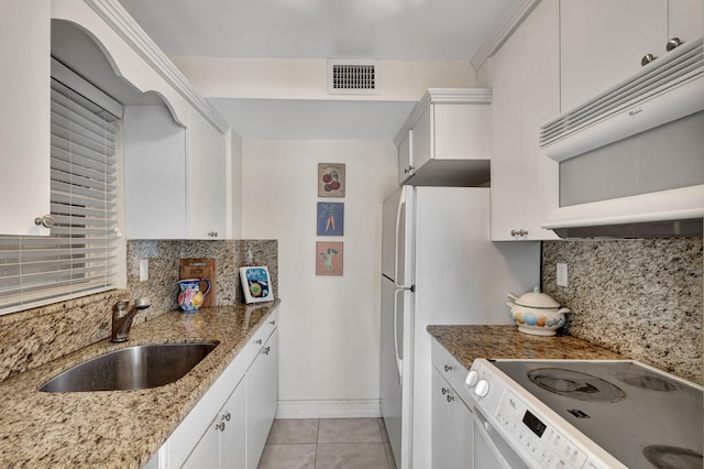 kitchen with white appliances, decorative backsplash, sink, and stone counters