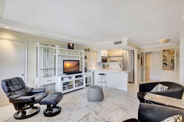 living room with ornamental molding and sink