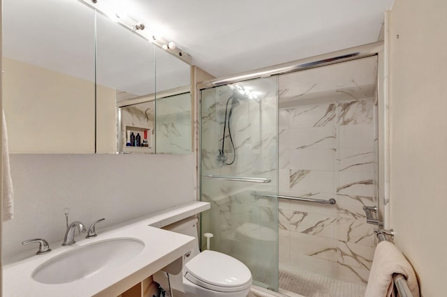 bathroom featuring walk in shower, toilet, and vanity