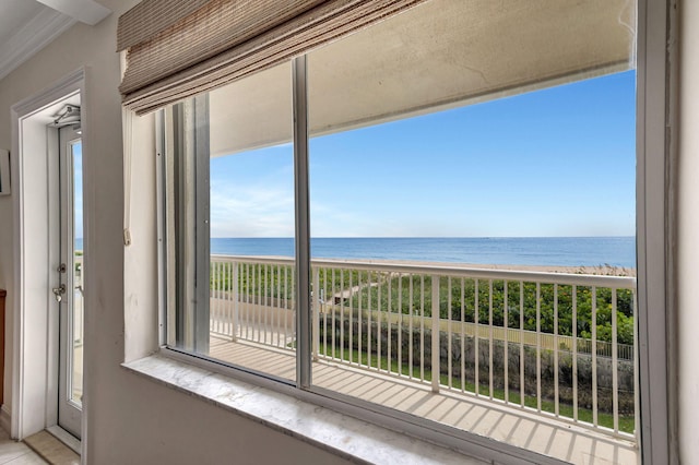 balcony featuring a beach view and a water view