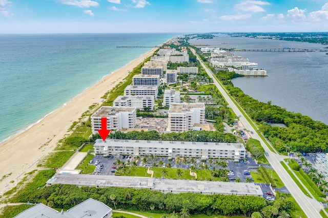 bird's eye view with a water view and a beach view