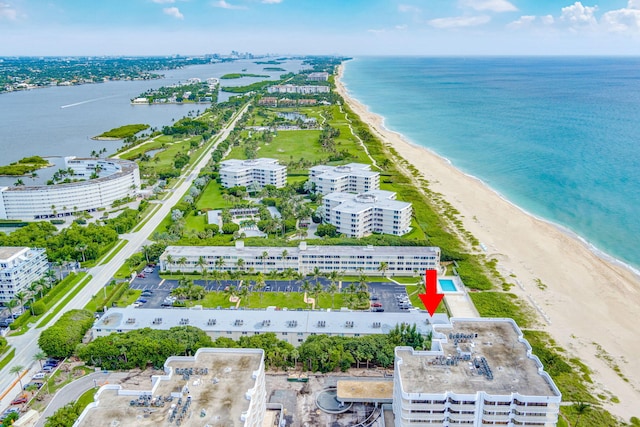 birds eye view of property featuring a view of the beach and a water view