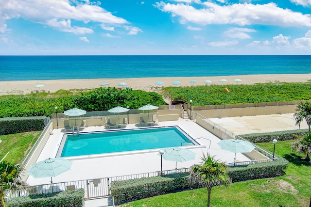 view of swimming pool with a water view and a patio area