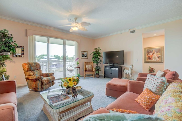 living room with carpet floors, ornamental molding, a textured ceiling, and ceiling fan