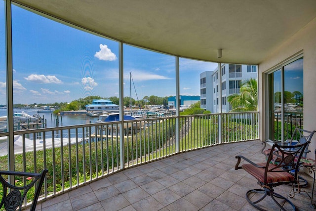 unfurnished sunroom with a water view