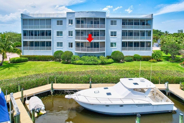 view of dock featuring a yard and a water view