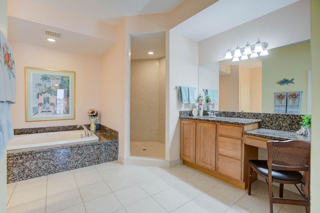 bathroom with plus walk in shower, vanity, and tile patterned flooring