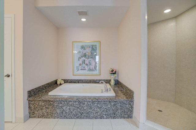 bathroom featuring tile patterned flooring and independent shower and bath