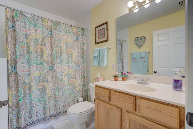 bathroom featuring vanity, toilet, a textured ceiling, and tile patterned floors