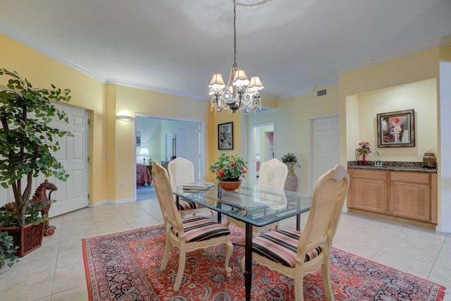 dining room featuring crown molding, an inviting chandelier, and light tile patterned floors