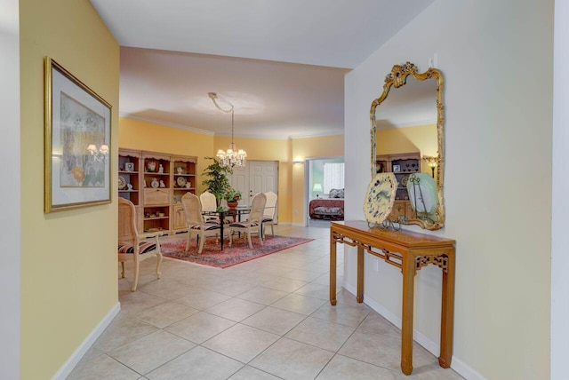 hall featuring an inviting chandelier, light tile patterned floors, and ornamental molding