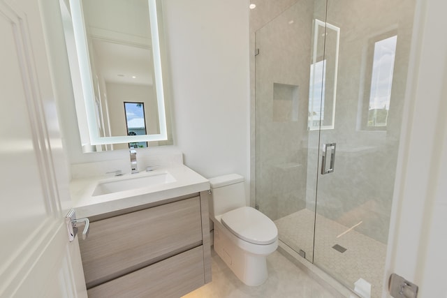 bathroom featuring vanity, toilet, walk in shower, and tile patterned floors