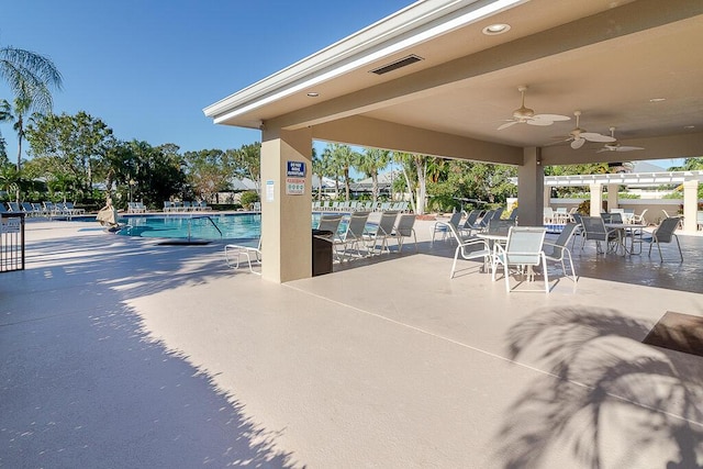 view of patio featuring ceiling fan and a community pool