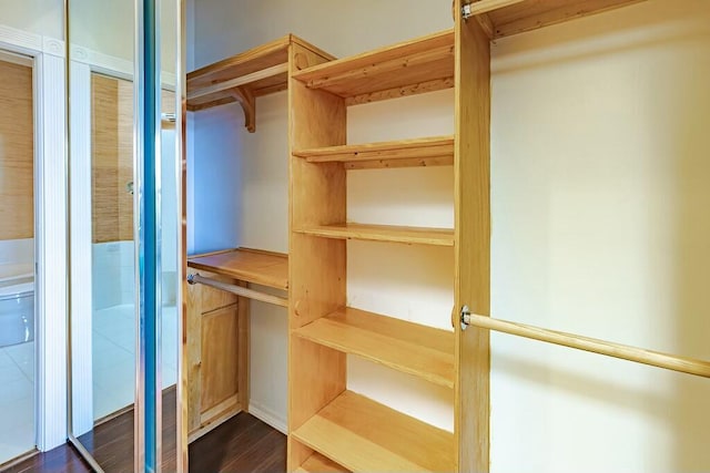 walk in closet featuring dark wood-type flooring