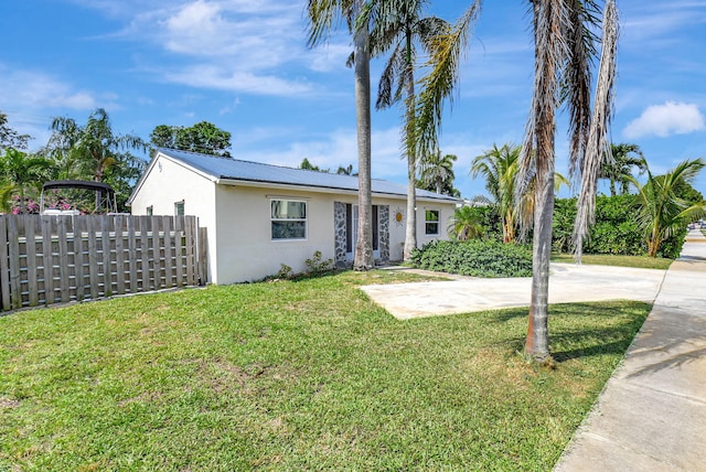 ranch-style home with a front lawn