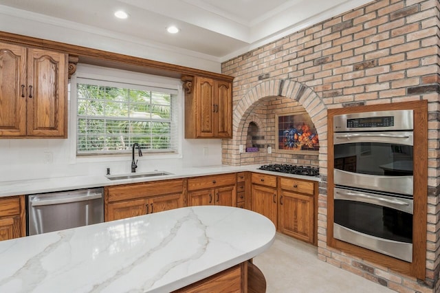 kitchen featuring crown molding, tasteful backsplash, stainless steel appliances, sink, and light stone countertops