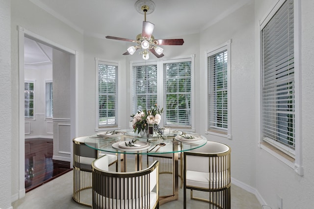 dining space featuring light wood-type flooring, ornamental molding, and ceiling fan