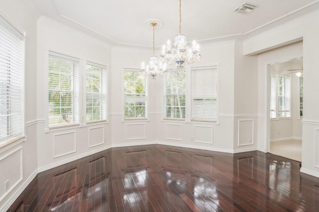 unfurnished dining area with ceiling fan with notable chandelier, hardwood / wood-style flooring, and crown molding