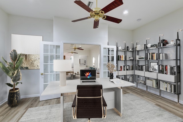 office space with light wood-type flooring and ceiling fan