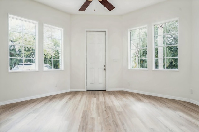 empty room with light wood-type flooring and ceiling fan