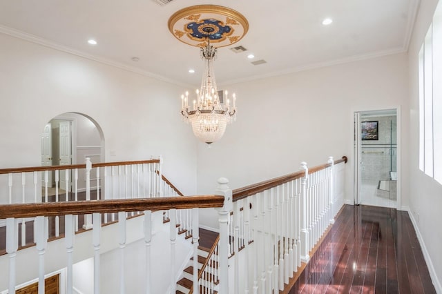 hallway featuring crown molding, dark hardwood / wood-style flooring, and a chandelier